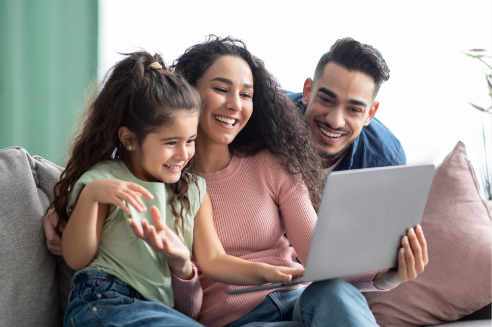 familia feliz compartiendo en casa mientras revisa información en una tablet
